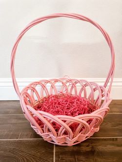 pink woven willow Easter basket featuring a scalloped rim and a tall arched handle