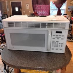 GE Over-the-Range Microwave – (White) handle is held with white tape on the bottom.
