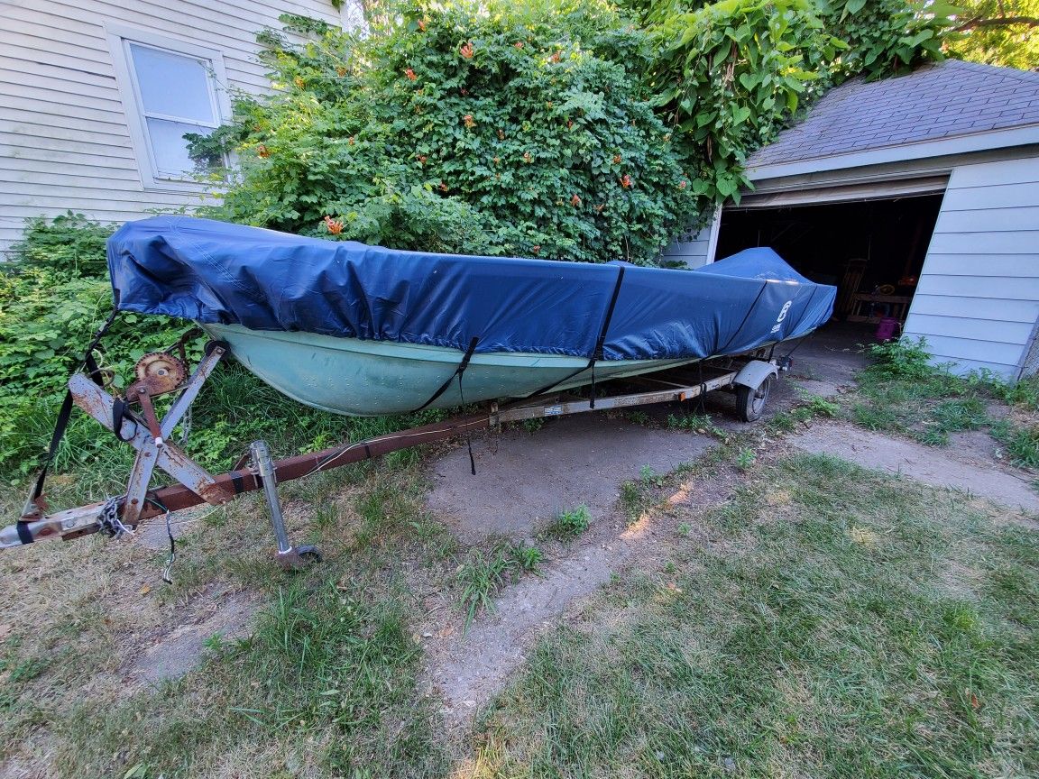 Fishing Boat (definitely  a fixer upper)  Motor and trailer come with it 