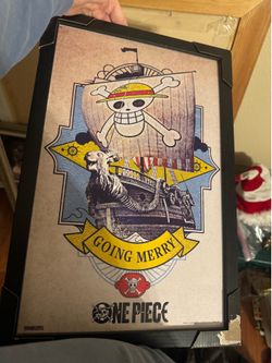 One Piece themed wall art featuring the Straw Hat Jolly Roger and the Going Merry ship