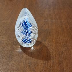 Vintage Hand Blown Art Glass Paperweight blue bubble center surrounded 
by white halo rings
The piece consists of a clear teardrop-shaped glass body c