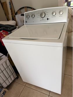 white Kenmore top-load washing machine featuring a rotary dial for cycle selection., works perfectly