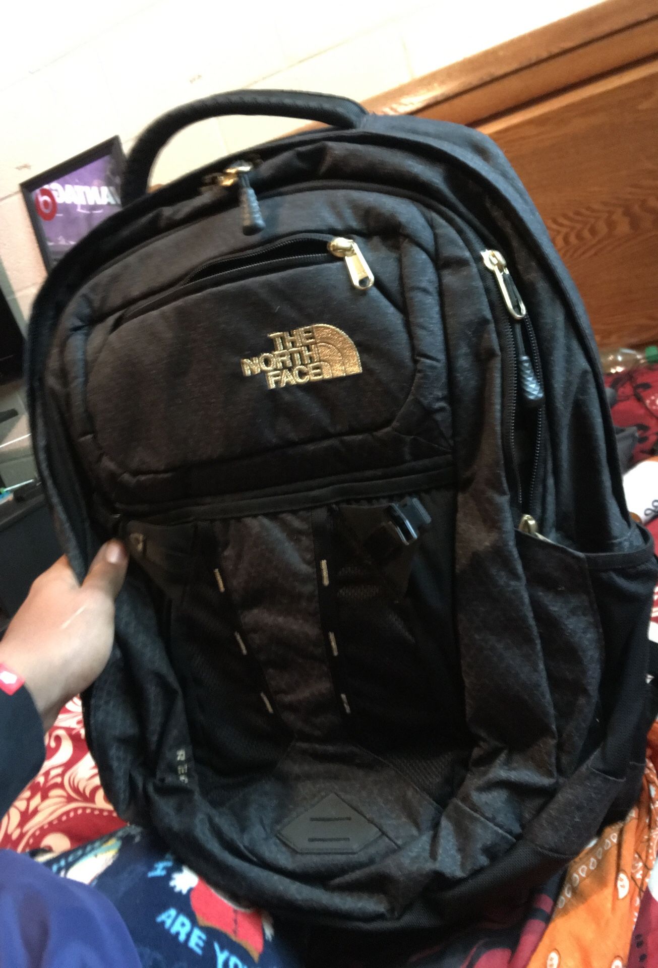 black and gold north face backpack