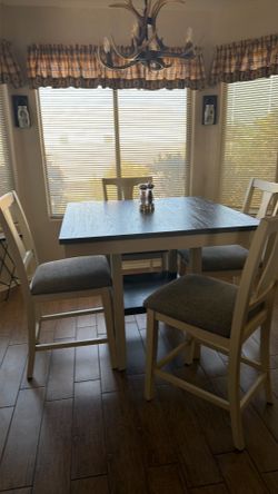 Solid wood dining room table and cushioned chairs