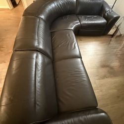 Black leather L shaped reclining couch