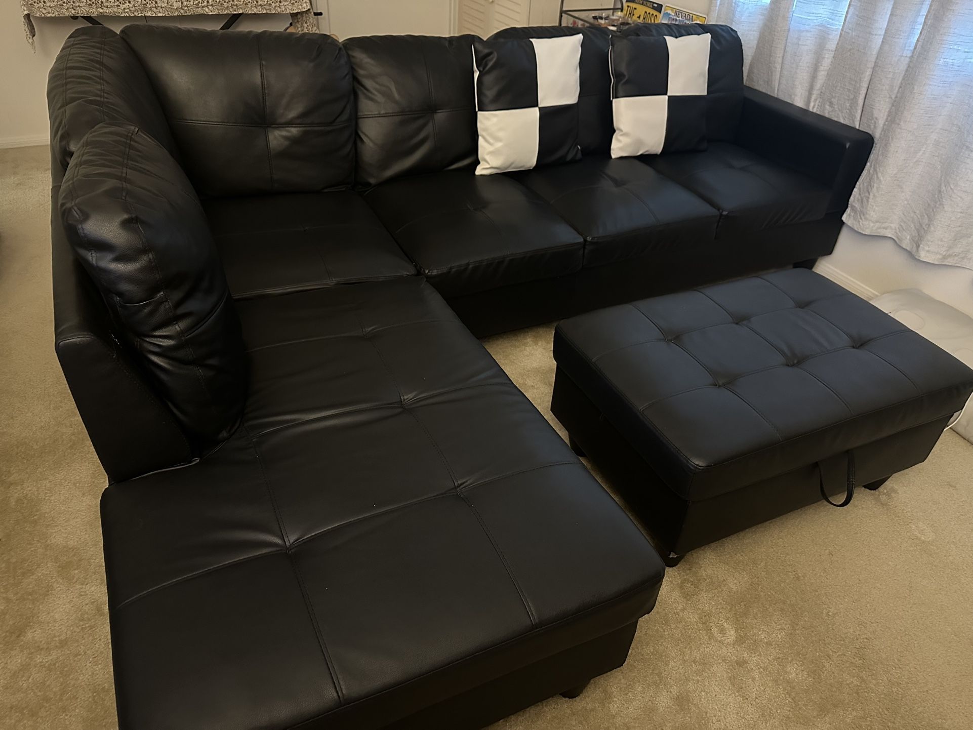 Black L Shaped Leather Sofa set with ottoman (has storage) and 2 pillows in excellent condition