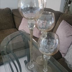 Three glass candle holders.