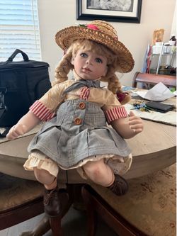 porcelain doll with blonde braided hair