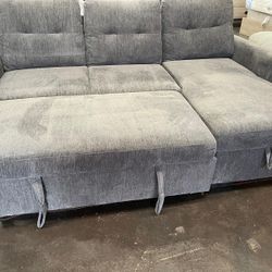 Gray Reversible Sectional with Pull Out Bed Ottoman