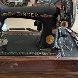 Vintage 1946 Singer Electric sewing machine with attachments.