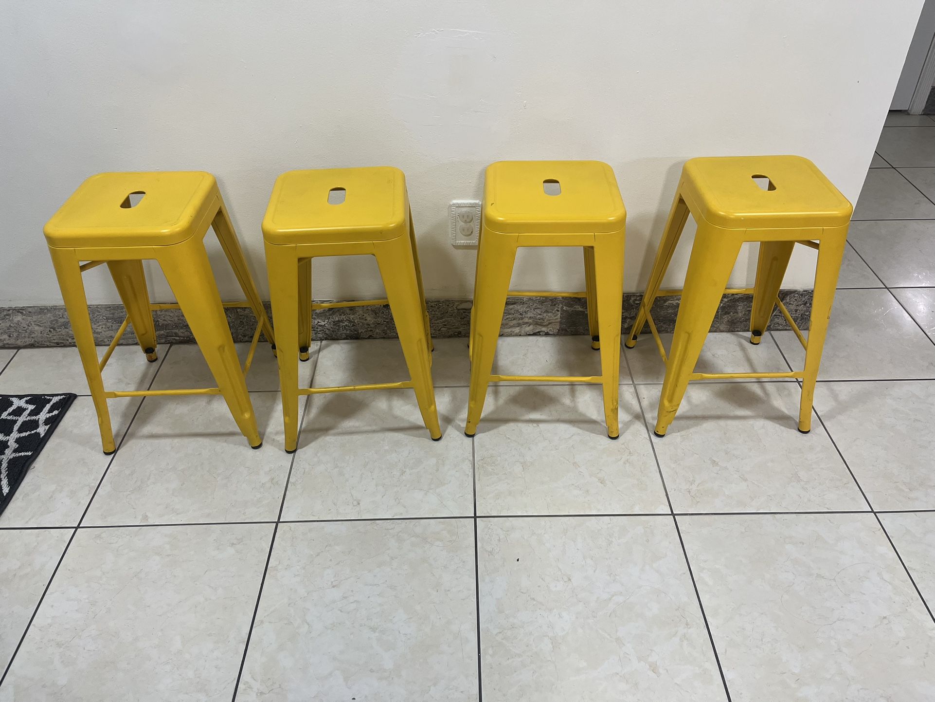 4 Yellow Metal Stools