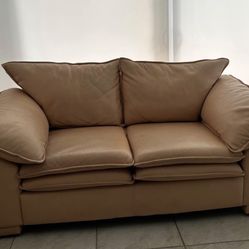 Golden Tan Leather Love Seat. Price Including Delivery 