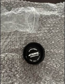 CNC aluminum brake fluid reservoir cap designed for Honda CBR1000RR motorcycles, featuring a black finish and a branded "CBR 1000RR" inlay.