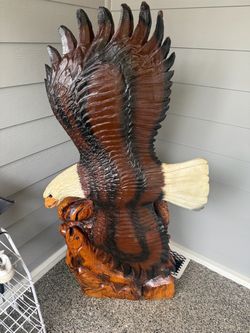 Wood art of a giant eagle catching fish