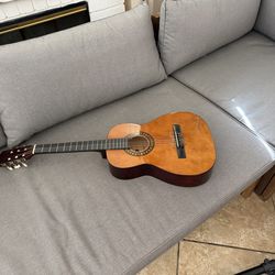 Acoustic guitar tuned and in good condition but strings are inverted