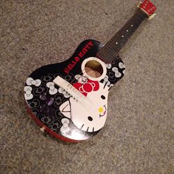 HELLO. KITTY GUITAR. ALL WOOD NO PLASTIC.   31  INCHES. LONG IN GREAT SHAPE. HARD TO FIND.  65 DOLLARS