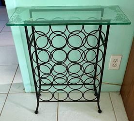 Black metal wine rack with glass table top. Holds 20 bottles. 2 pieces.