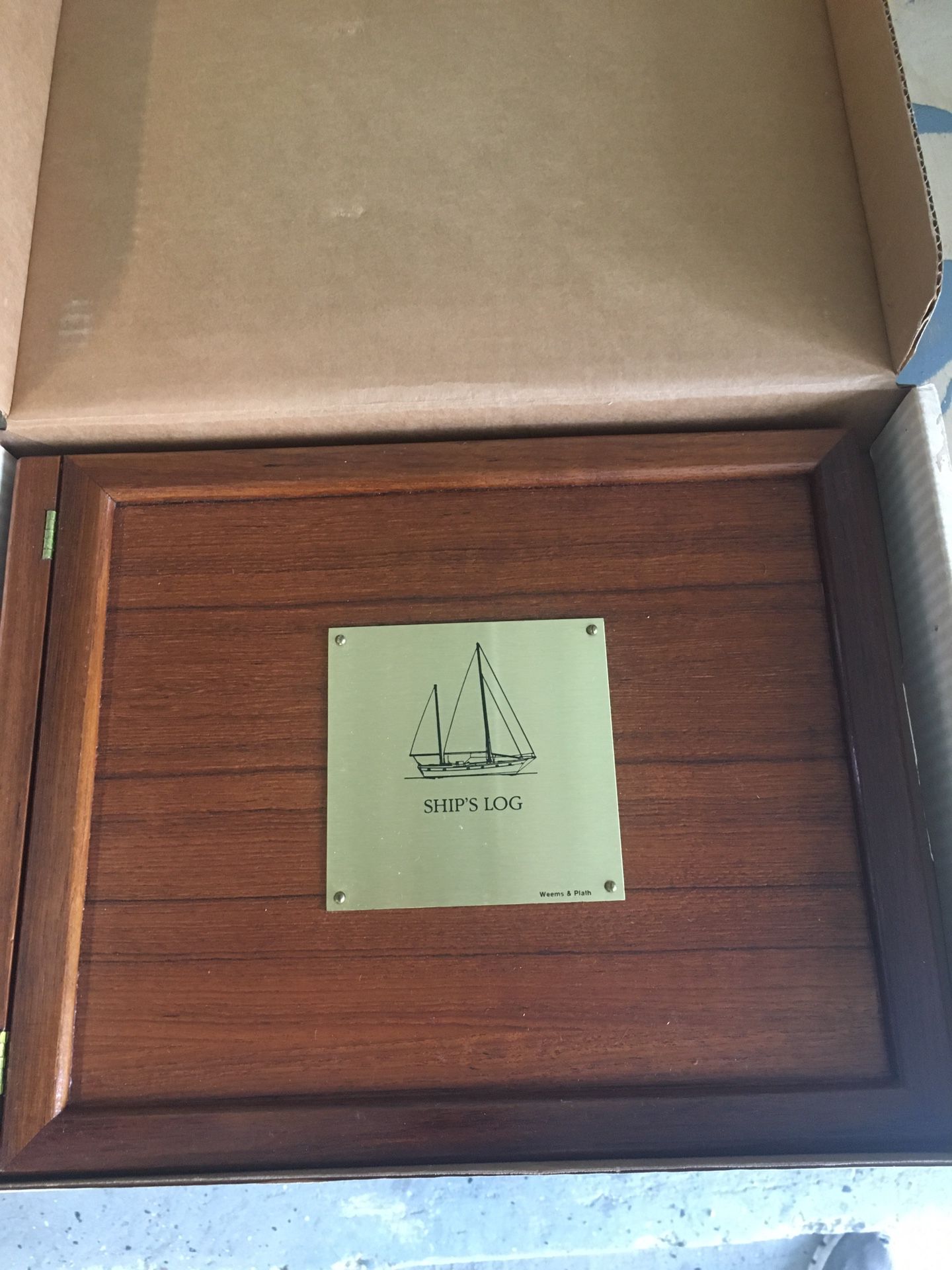 Teak logbook cover with logbook for sailboat