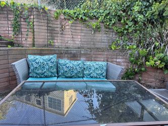 Outdoor Wicker Sofa with Cushions and Glass Table