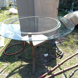 38inch Around And In Like New Cond Metal Framed Table With Round Glass Piece On top. Glass Is Beveled And Is In Great Cond No Chips Or Cracks 