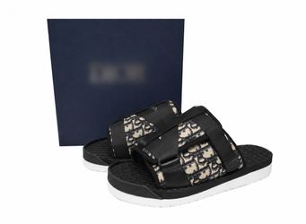 Black D..I..O..R slides with textured woven pattern