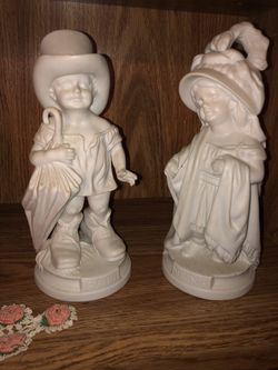 Pair of boy & girl statues