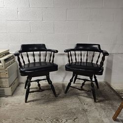 Pair of vintage Buckstaff oak swivel captain's chairs - black naugahyde upholstery. 