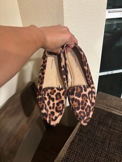 Woman’s cheetah flats and black heels