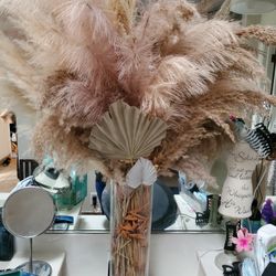 Decorative Feathers In A Glass Vase 