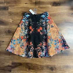 Brand new woman’s Bebe brand “Tall Tail” Floral skirt up for sale 