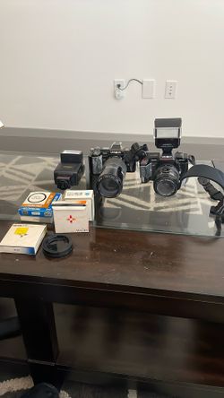 Two Minolta Cameras And Lenses