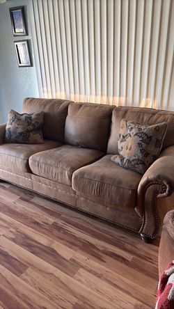 Two identical brown sleeper sofas