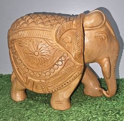 Hand-carved wooden elephant figurine  from India, crafted from Kadam https://offerup.com/redirect/?o=d29vZC5JdA== features intricate details, such as 