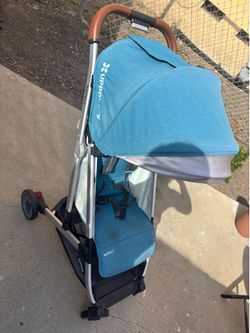 UPPAbaby MINU stroller in the Teal Melange color with a saddle leather handle
