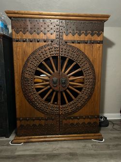 Rustic Wood Armoire with Wagon Wheel Doors