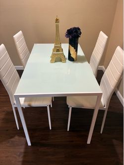 White Table set with 4 chairs and decorations minus the flowers and vase