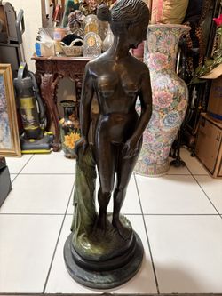 classical-style bronze nude female figure with a draped cloth beside her and a green marble base. 37 Inches Tall. Artist signature