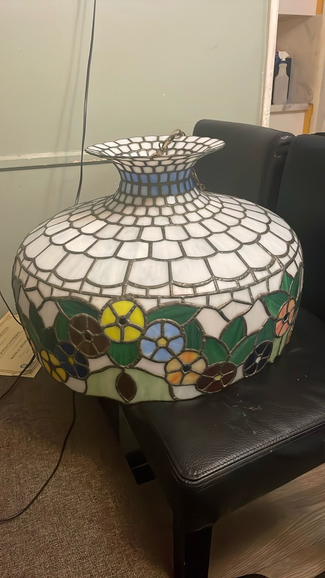 This is a large stained glass lamp shade featuring a floral pattern with vibrant colors. It is signed by John J. Beyea and dated 3-23-81, indicating i