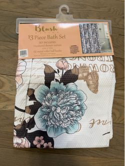 Luv Betsey Blush Design 13 Piece Shower Curtain Set. The set includes one 72in x 72in textured shower curtain and 12 metal roller ball hooks, and the