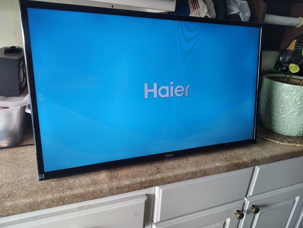 Haier 32" TV with remote and wall mounting bracket