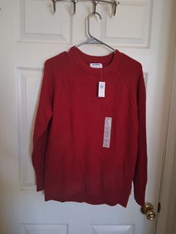 This is an Old Navy red crew-neck sweater featuring a textured knit and ribbed trim.
