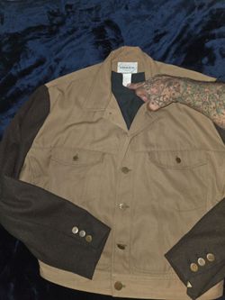 vintage two-tone jacket by the designer brand Marithé + François Girbaud, featuring a tan/khaki canvas body and contrasting dark sleeves.