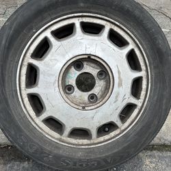 One 92-93 Honda Acord 15 inch Aluminum rim and old tire. 4 on 4.5 lugs