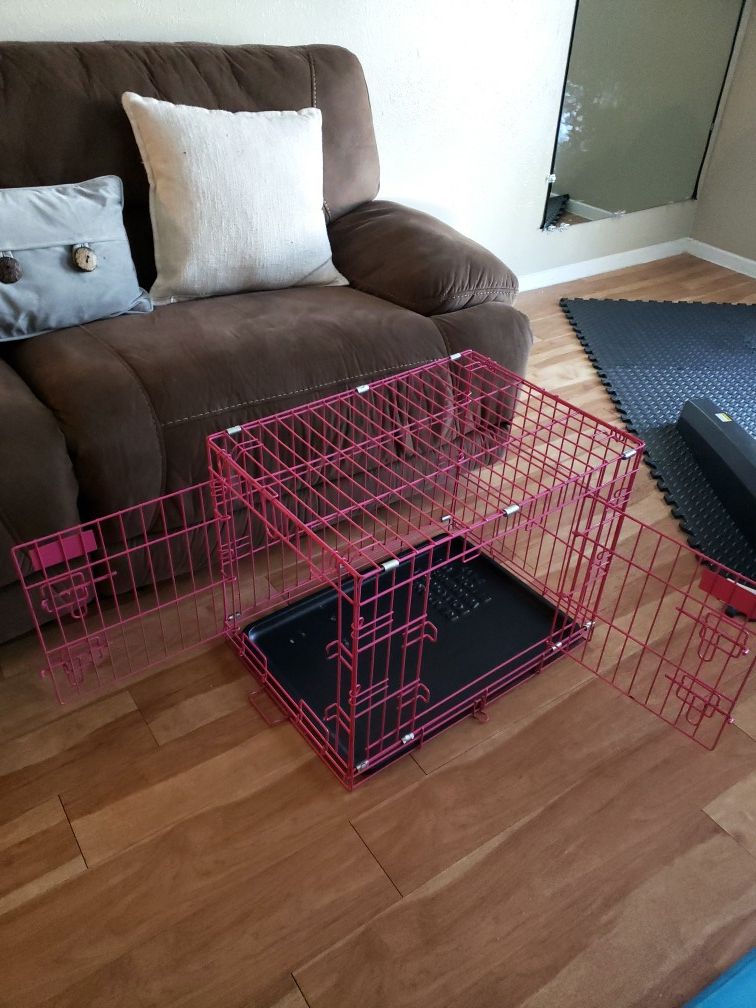 Pink crate for medium or small dog .