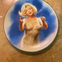This item is a decorative collector plate featuring Marilyn Monroe.     