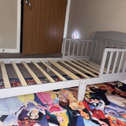 Gray toddler bed with 2 side rails 