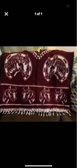 Really nice poncho has horses on both sides