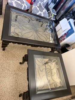 2 dark wood and glass tables