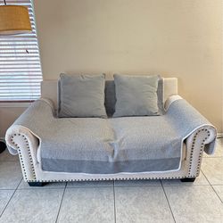Two-seater sofa set with 2 throw pillows for sale.