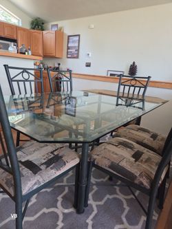 Glass top  metal dining table with 6 matching chairs,